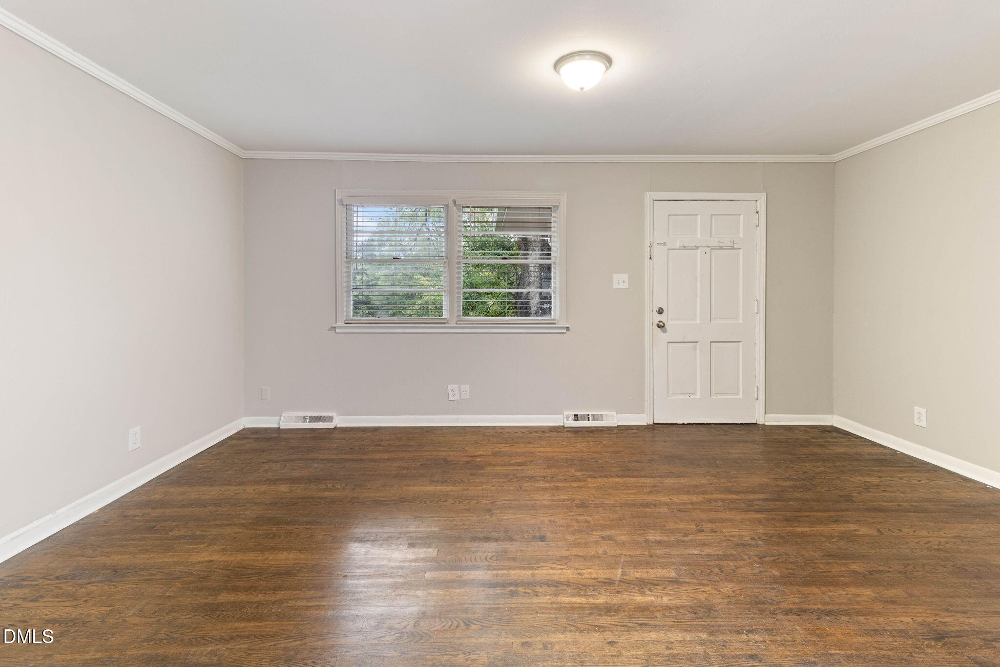 1814 House Avenue, Unit A Durham, NC 27707 - Photo 4 of 12 an empty room with wooden floor and windows