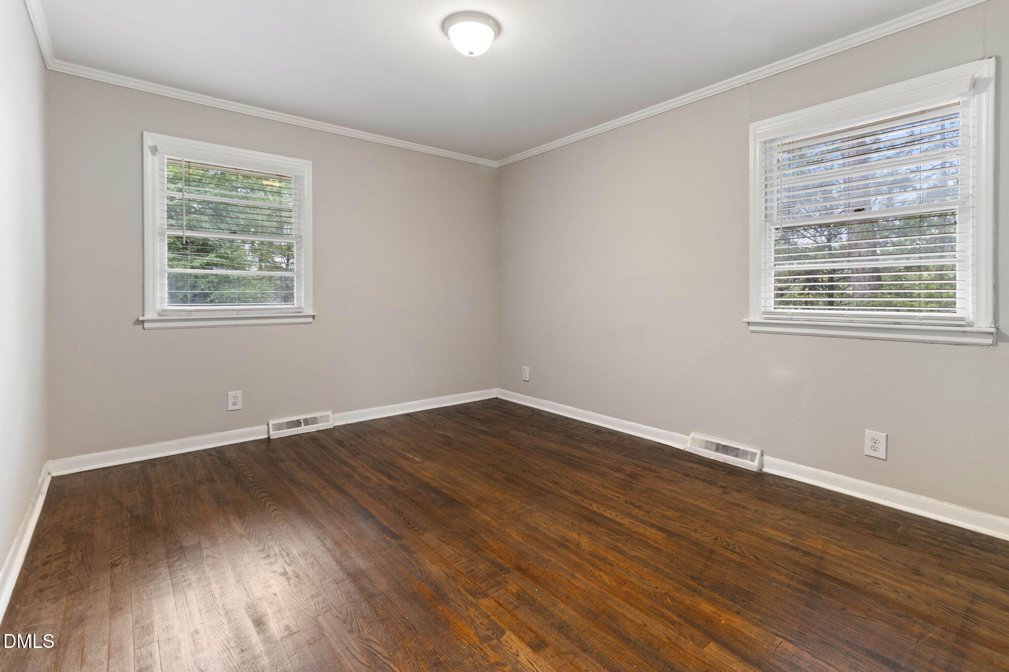 1814 House Avenue, Unit A Durham, NC 27707 - Photo 6 of 12 a view of an empty room with wooden floor and a window