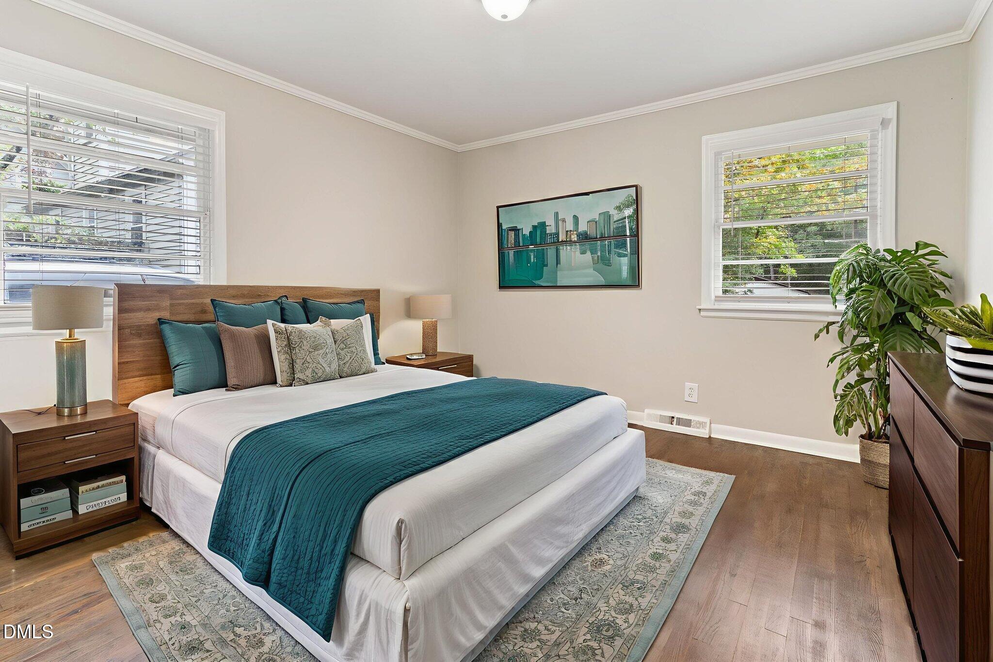 1814 House Avenue, Unit A Durham, NC 27707 - Photo 9 of 12 a bedroom with a large bed and a potted plant