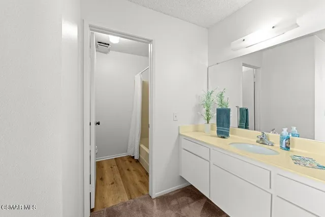 a en suite bathroom with a sink and mirror