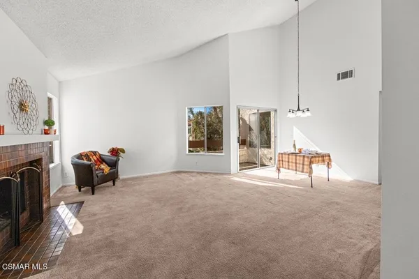 a view of a livingroom with furniture and a fireplace