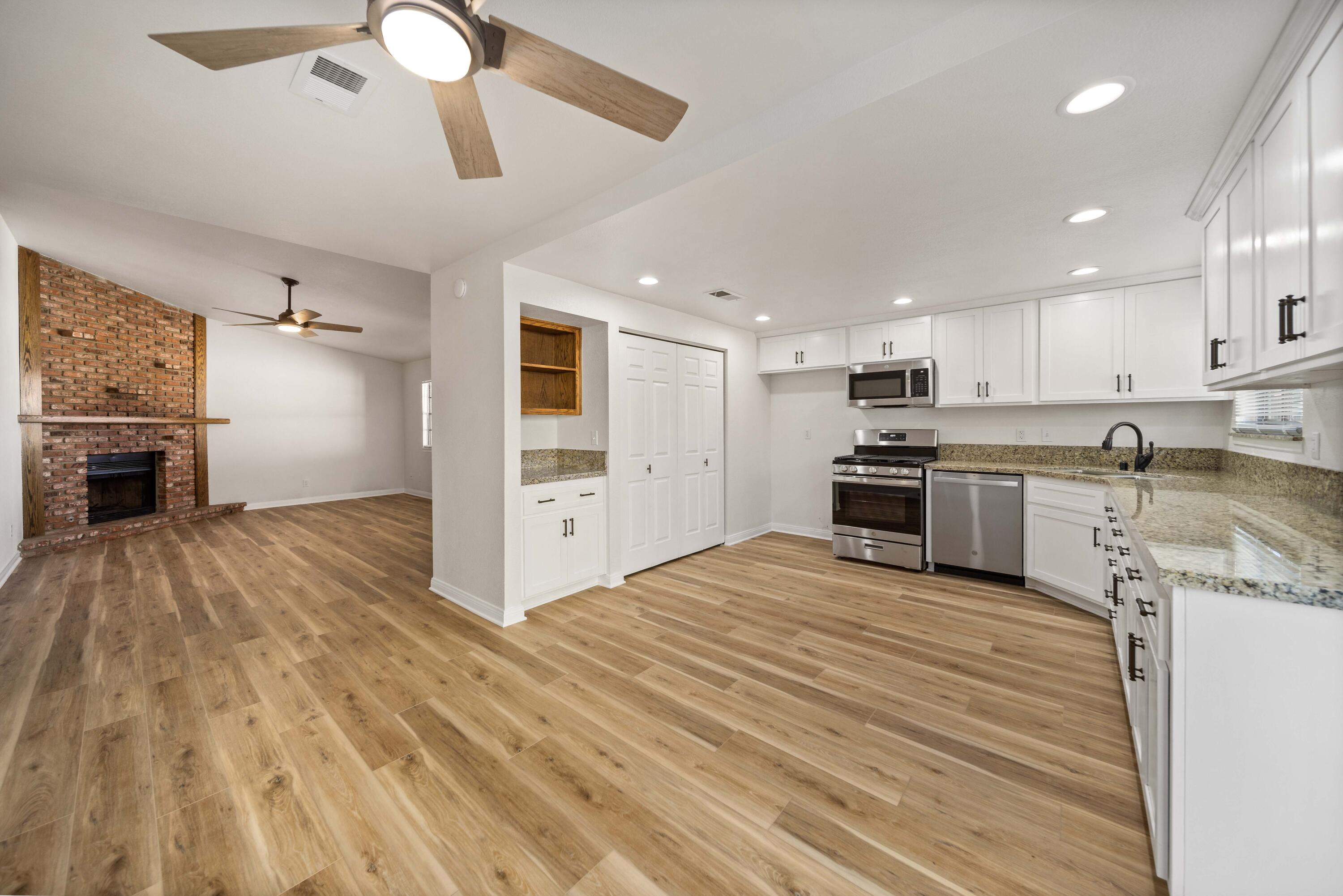 43734 Frieda Court Lancaster, CA 93535 - Photo 11 of 32 a large kitchen with stainless steel appliances granite countertop a stove and a refrigerator