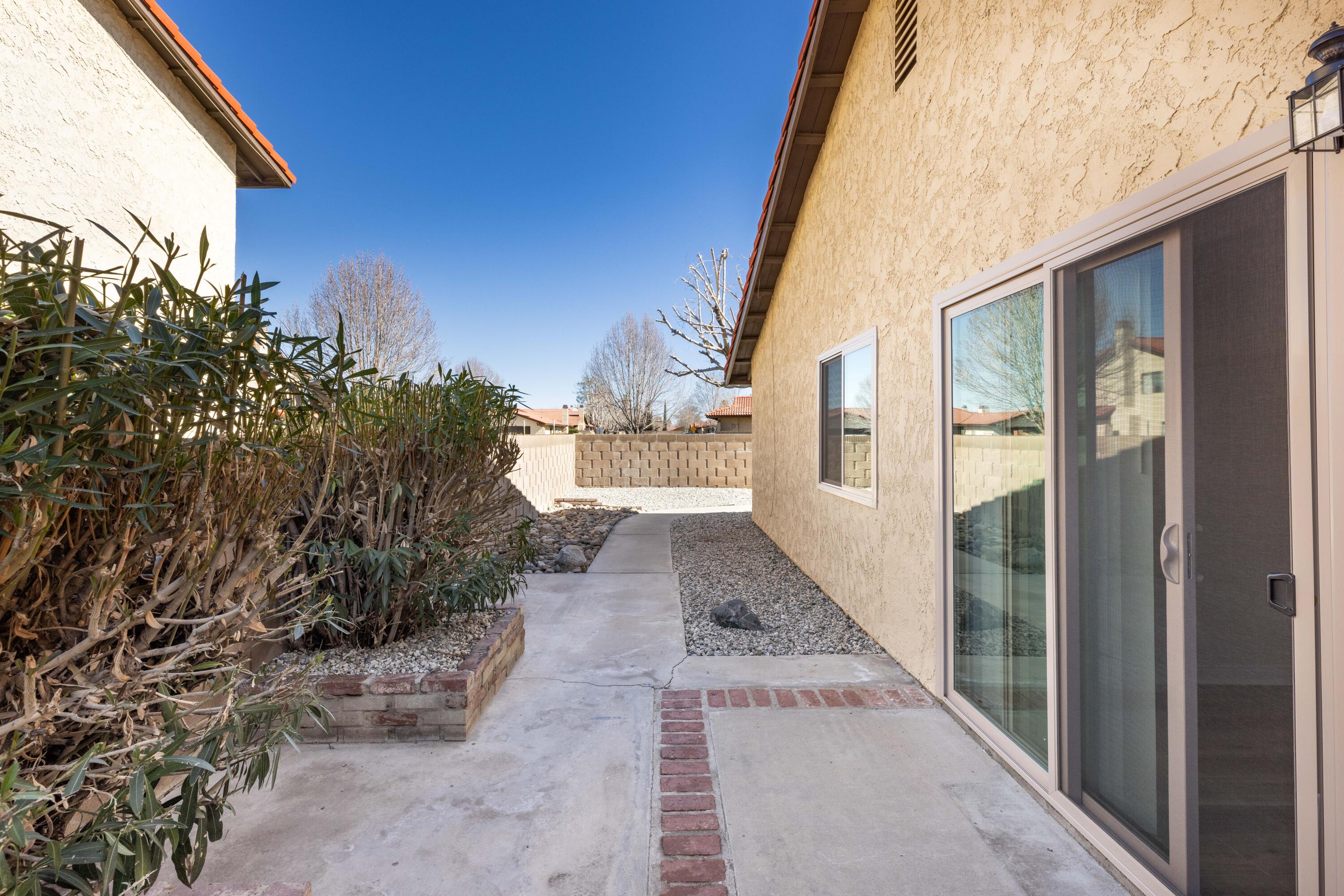 43734 Frieda Court Lancaster, CA 93535 - Photo 28 of 32 a view of a pathway of a house with yard