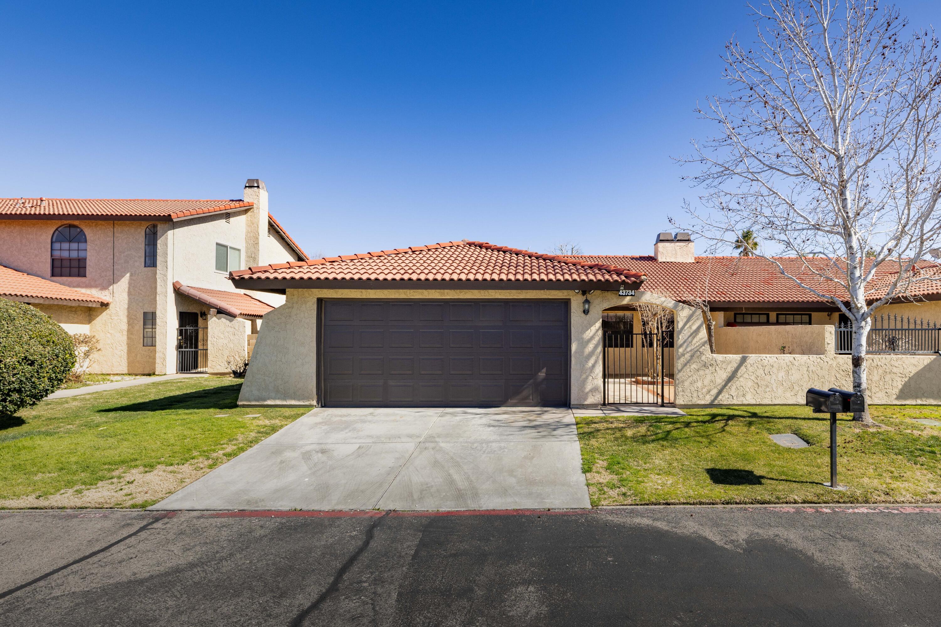 43734 Frieda Court Lancaster, CA 93535 - Photo 3 of 32 a front view of a house with a yard and garage