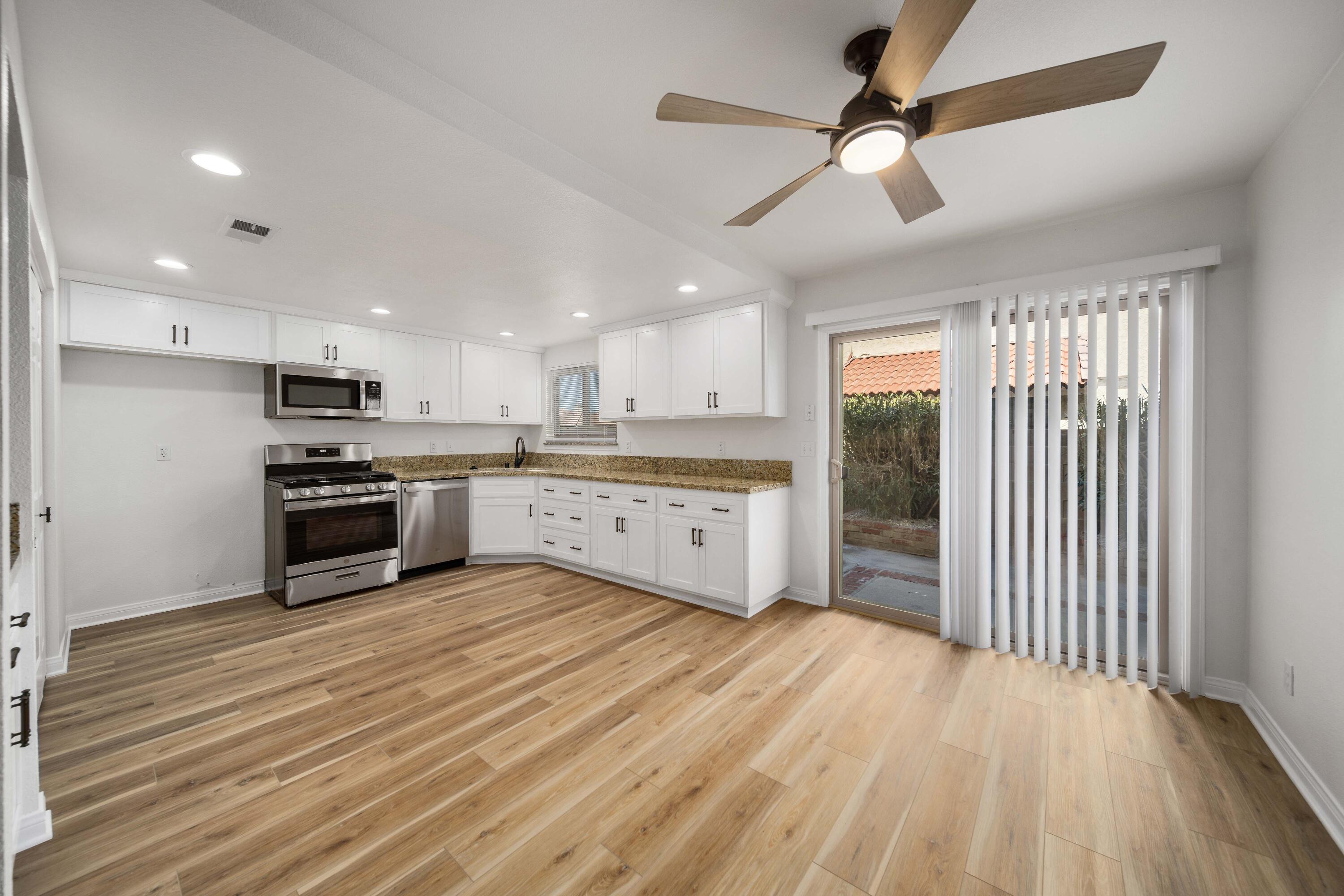 43734 Frieda Court Lancaster, CA 93535 - Photo 8 of 32 a large kitchen with stainless steel appliances granite countertop a stove a sink and a refrigerator