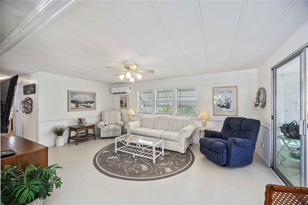 10303 Burnt Store Road, Unit 221 Punta Gorda, FL 33950 - Photo 11 of 31 a living room with furniture potted plant and a window
