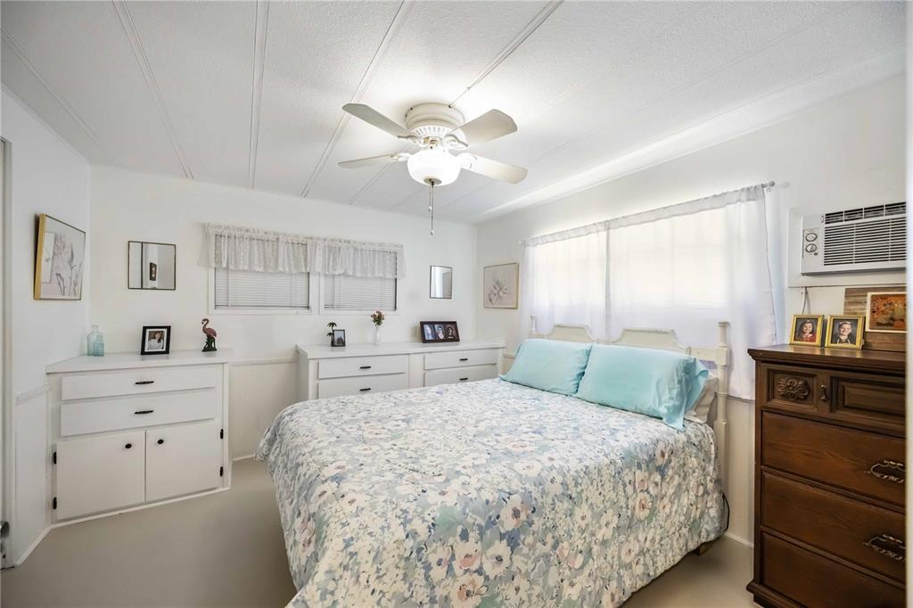 10303 Burnt Store Road, Unit 221 Punta Gorda, FL 33950 - Photo 13 of 31 a bedroom with a bed and a dresser