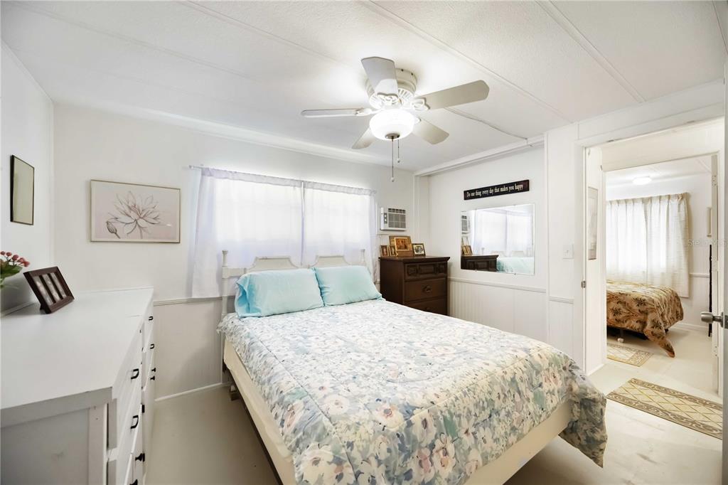 10303 Burnt Store Road, Unit 221 Punta Gorda, FL 33950 - Photo 14 of 31 a bedroom with a large bed and a chandelier
