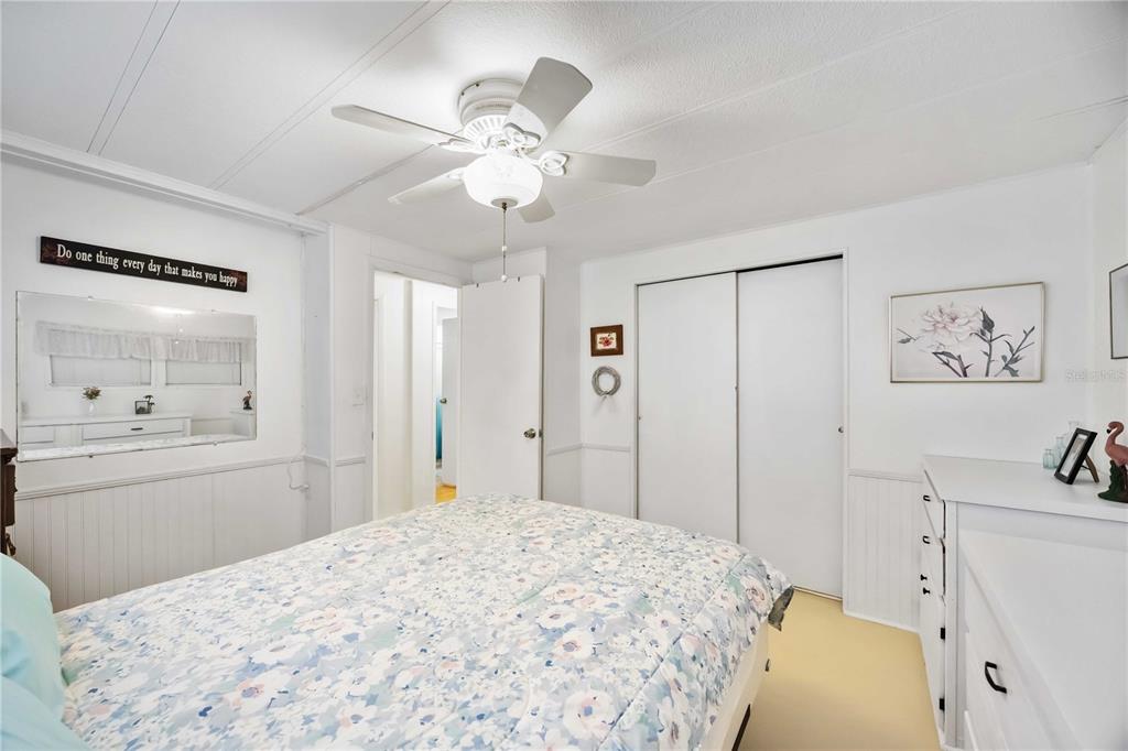 10303 Burnt Store Road, Unit 221 Punta Gorda, FL 33950 - Photo 15 of 31 a bedroom with a bed and a chandelier