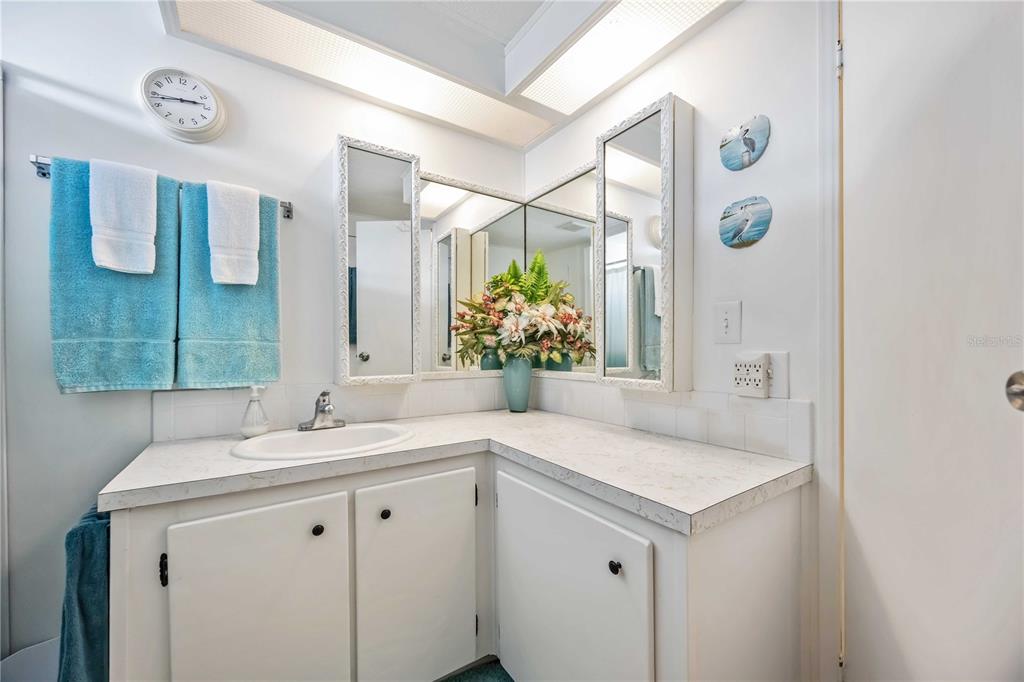 10303 Burnt Store Road, Unit 221 Punta Gorda, FL 33950 - Photo 16 of 31 a bathroom with a sink and a mirror