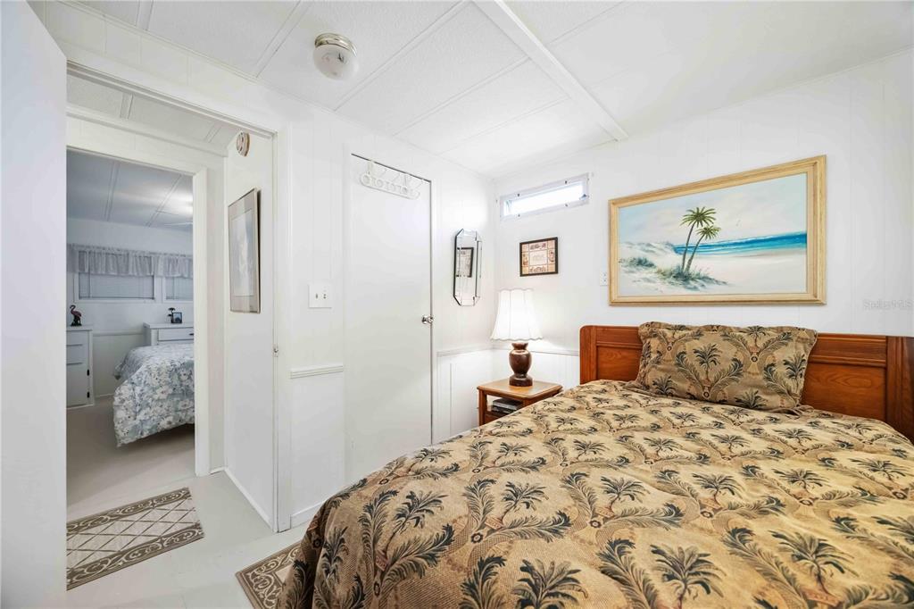 10303 Burnt Store Road, Unit 221 Punta Gorda, FL 33950 - Photo 18 of 31 a bedroom with a large bed and walk in closet