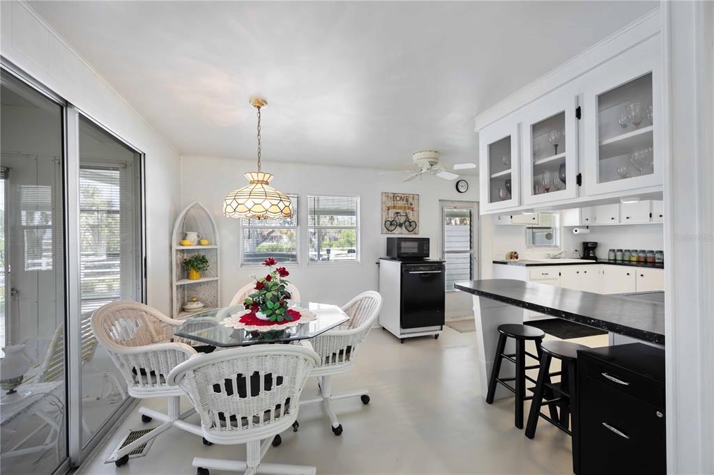 10303 Burnt Store Road, Unit 221 Punta Gorda, FL 33950 - Photo 6 of 31 a living room with furniture and a chandelier