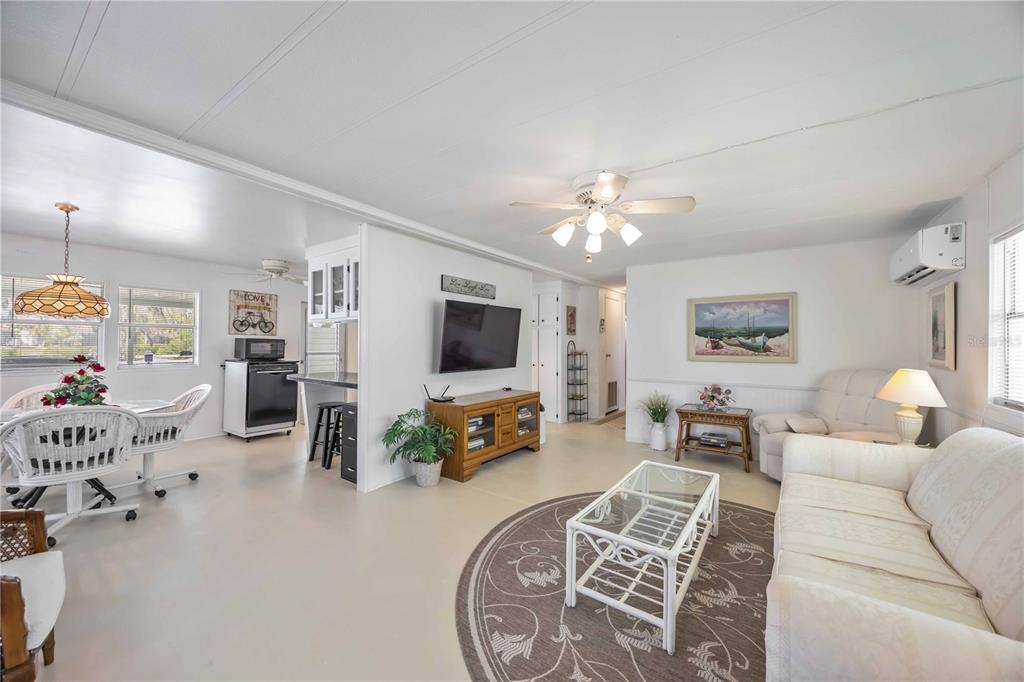 10303 Burnt Store Road, Unit 221 Punta Gorda, FL 33950 - Photo 10 of 31 a living room with furniture and a flat screen tv