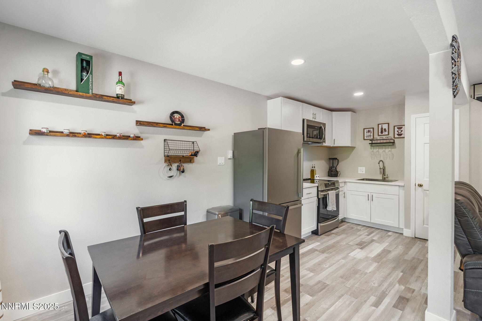 940 Jamaica Avenue, Unit 3 Reno, NV 89502 - Photo 15 of 29 a kitchen with refrigerator cabinets dining table and chairs