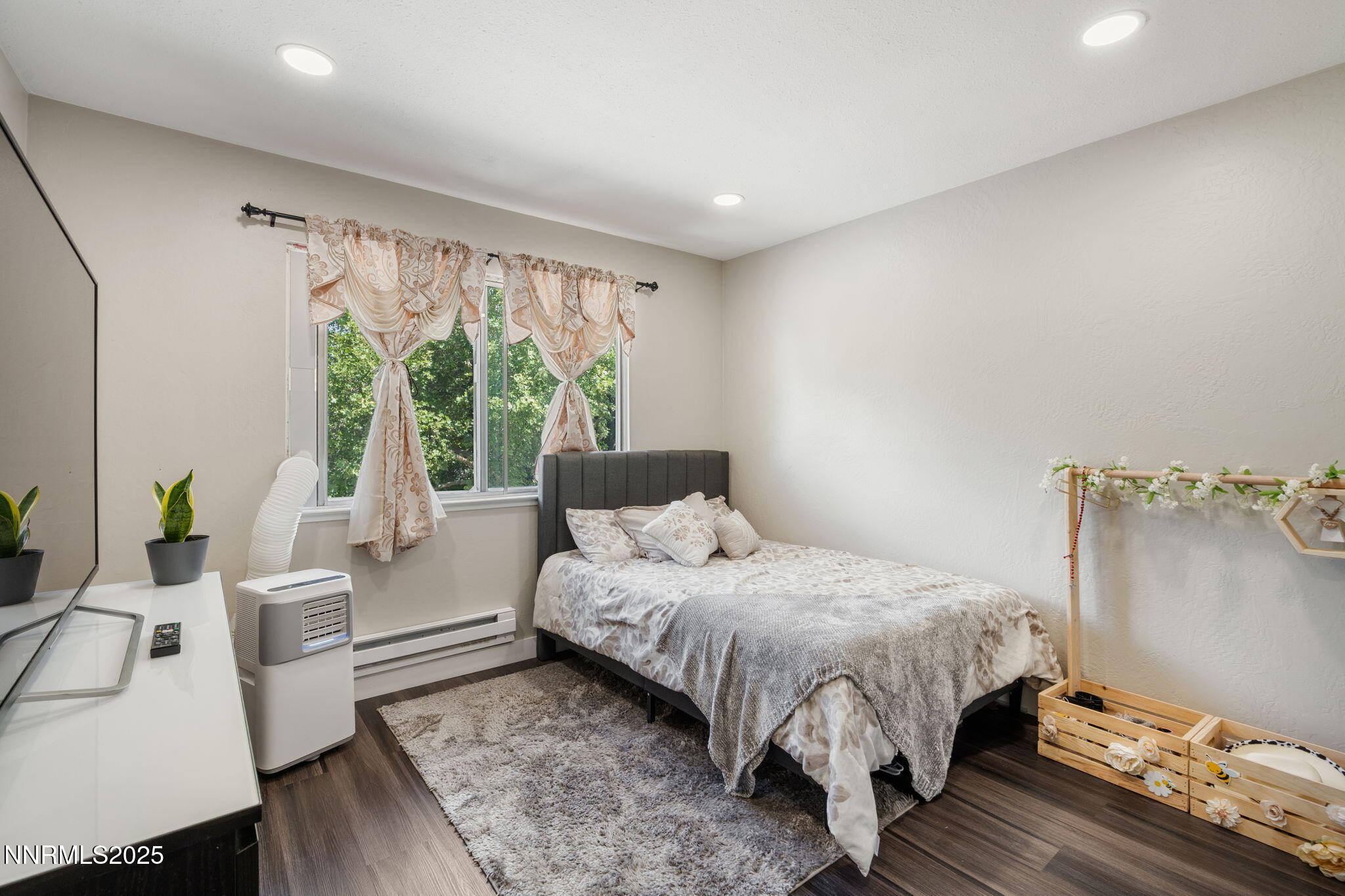 940 Jamaica Avenue, Unit 3 Reno, NV 89502 - Photo 22 of 29 a bed sitting in a spacious bedroom next to a window