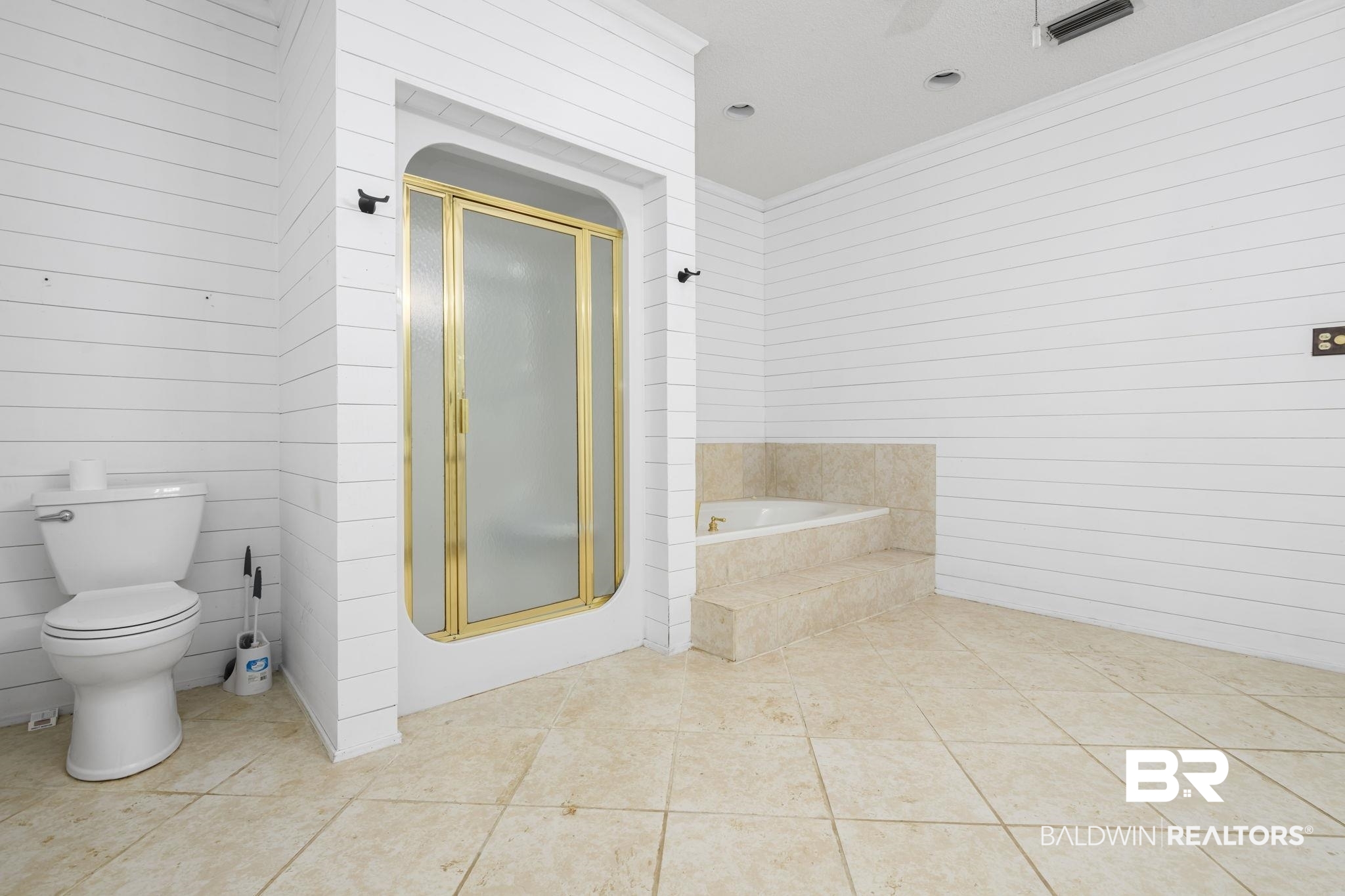 7540 2 Mile Road Irvington, AL 36544 - Photo 35 of 82 Bathroom featuring a gold-framed shower enclosure, built-in bathtub with tiled surround, white shiplap walls, and neutral-toned tile flooring