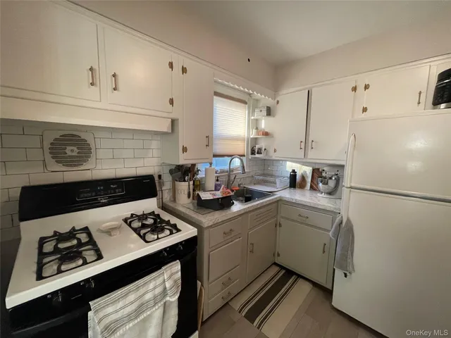 a kitchen with a stove cabinets and refrigerator