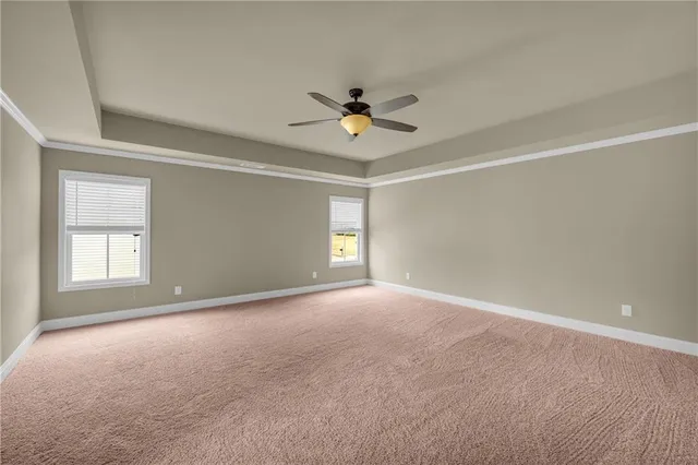 a view of a livingroom with a ceiling fan and window