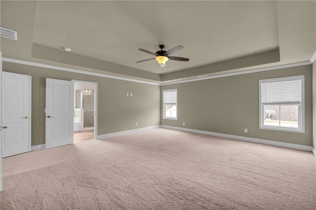 a view of an empty room with a ceiling fan