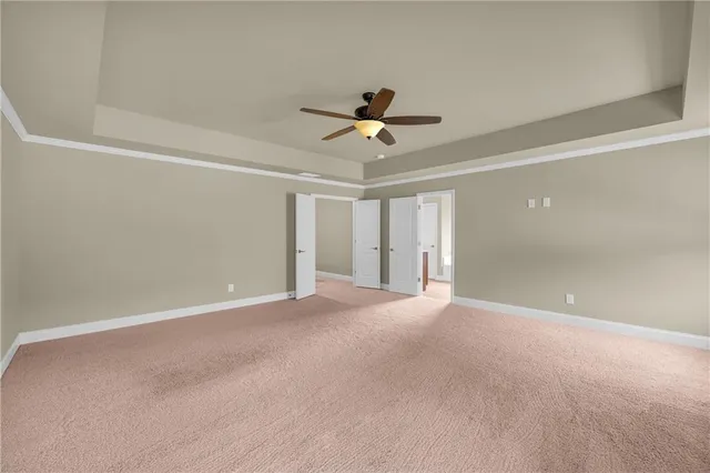a spacious bathroom with a granite countertop sink mirror and shower