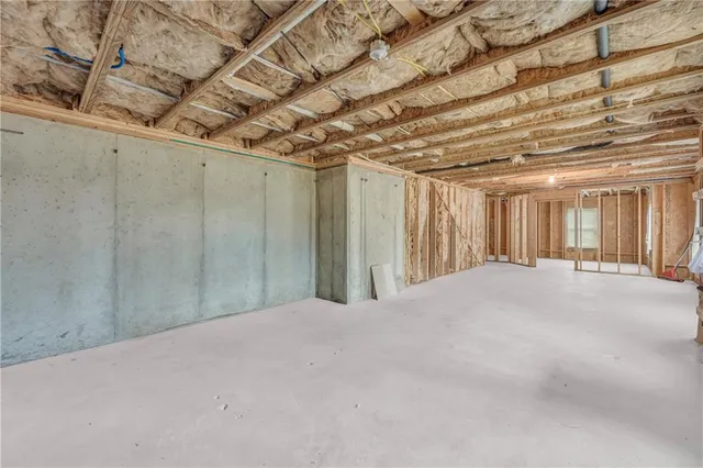 a white house covered with snow in front of house