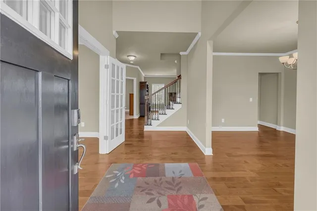 a view of a hallway with wooden floor