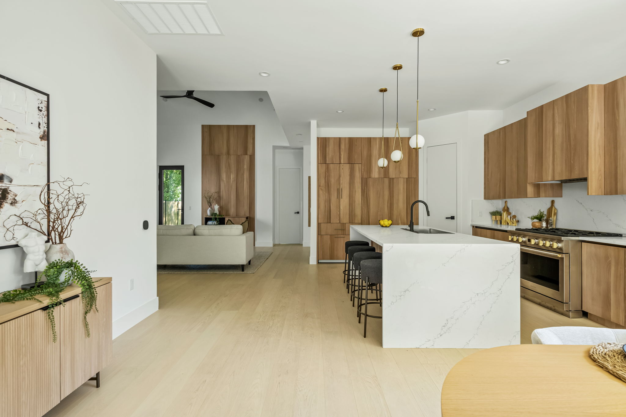 3210 Thompson Street Austin, TX 78702 - Photo 5 of 39 An open concept design seamlessly blends the kitchen with a sun-filled living area.