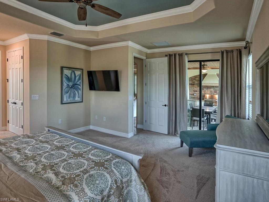 2850 Aviamar Circle Naples, FL 34114 - Photo 13 of 26 a bedroom with a large bed and a couch