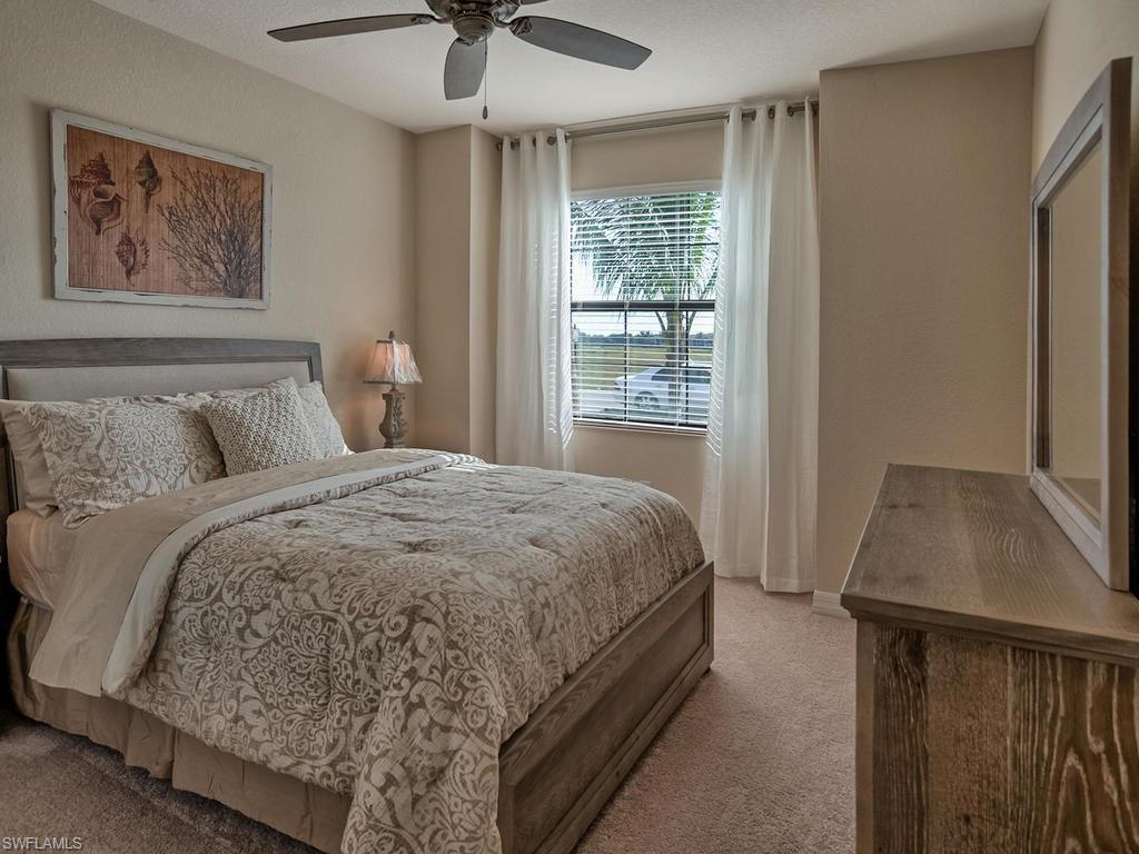 2850 Aviamar Circle Naples, FL 34114 - Photo 16 of 26 a bedroom with a bed and a window
