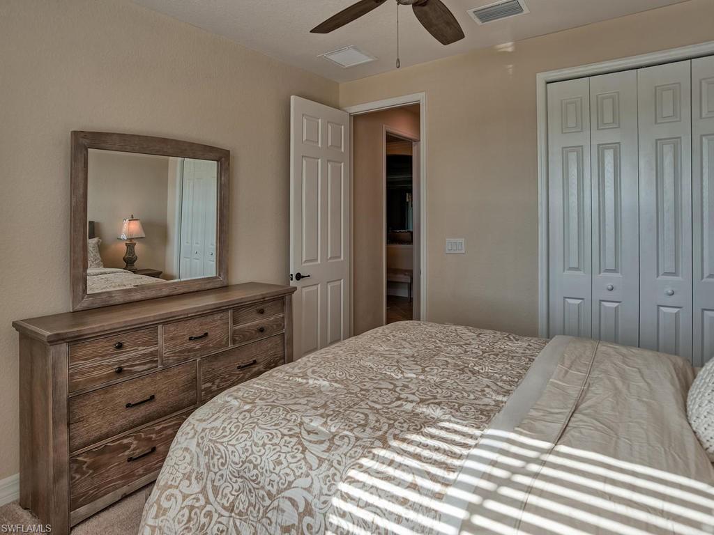 2850 Aviamar Circle Naples, FL 34114 - Photo 17 of 26 a bedroom with a bed and a dresser