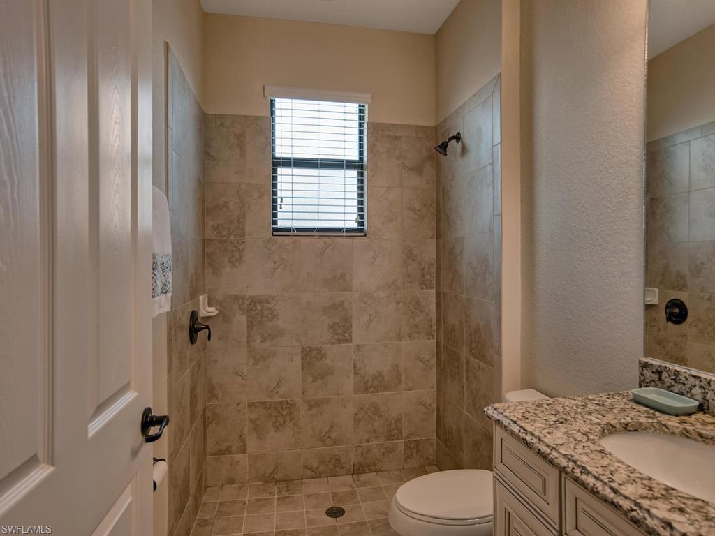 2850 Aviamar Circle Naples, FL 34114 - Photo 18 of 26 a bathroom with a granite countertop toilet sink and shower