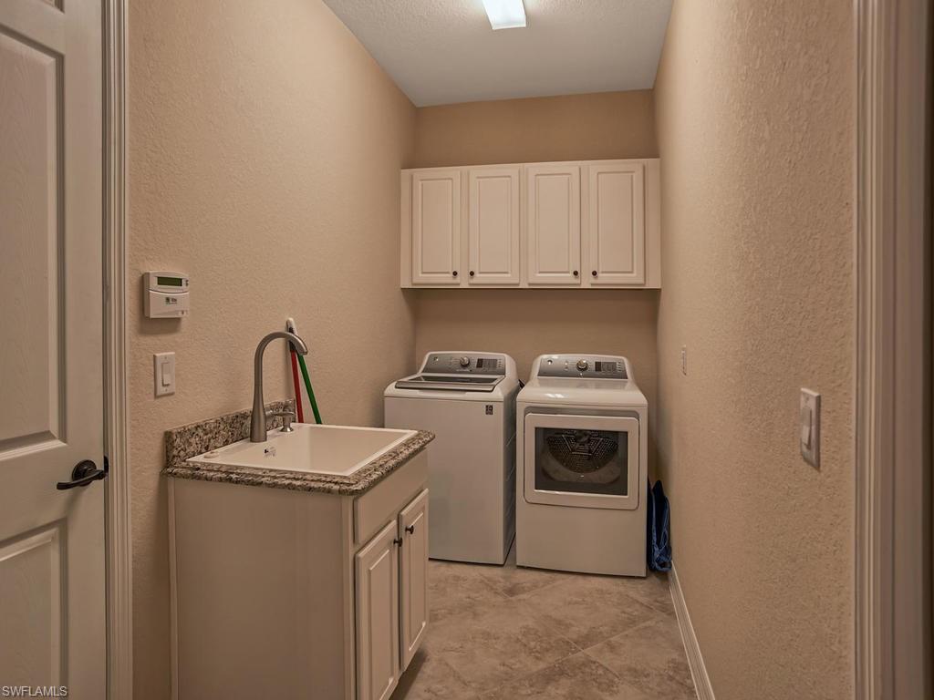 2850 Aviamar Circle Naples, FL 34114 - Photo 20 of 26 a utility room with sink dryer and washer