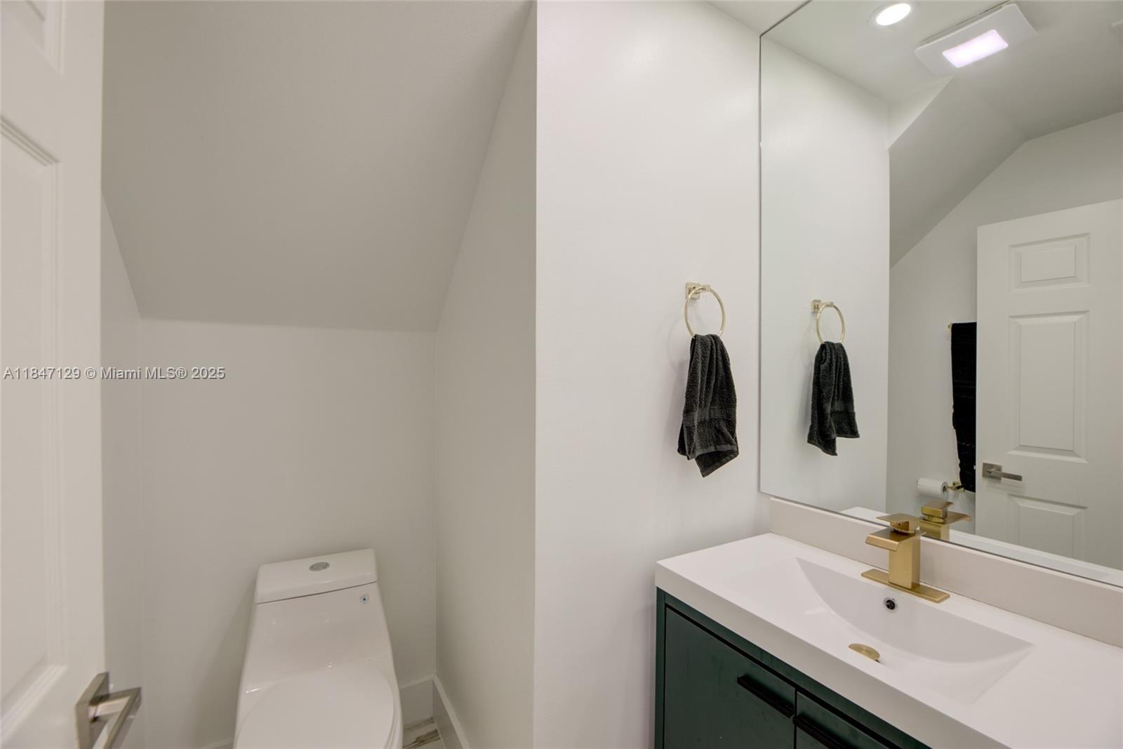 6073 Spring Isles Boulevard Lake Worth, FL 33463 - Photo 25 of 51 a bathroom with a sink and a mirror