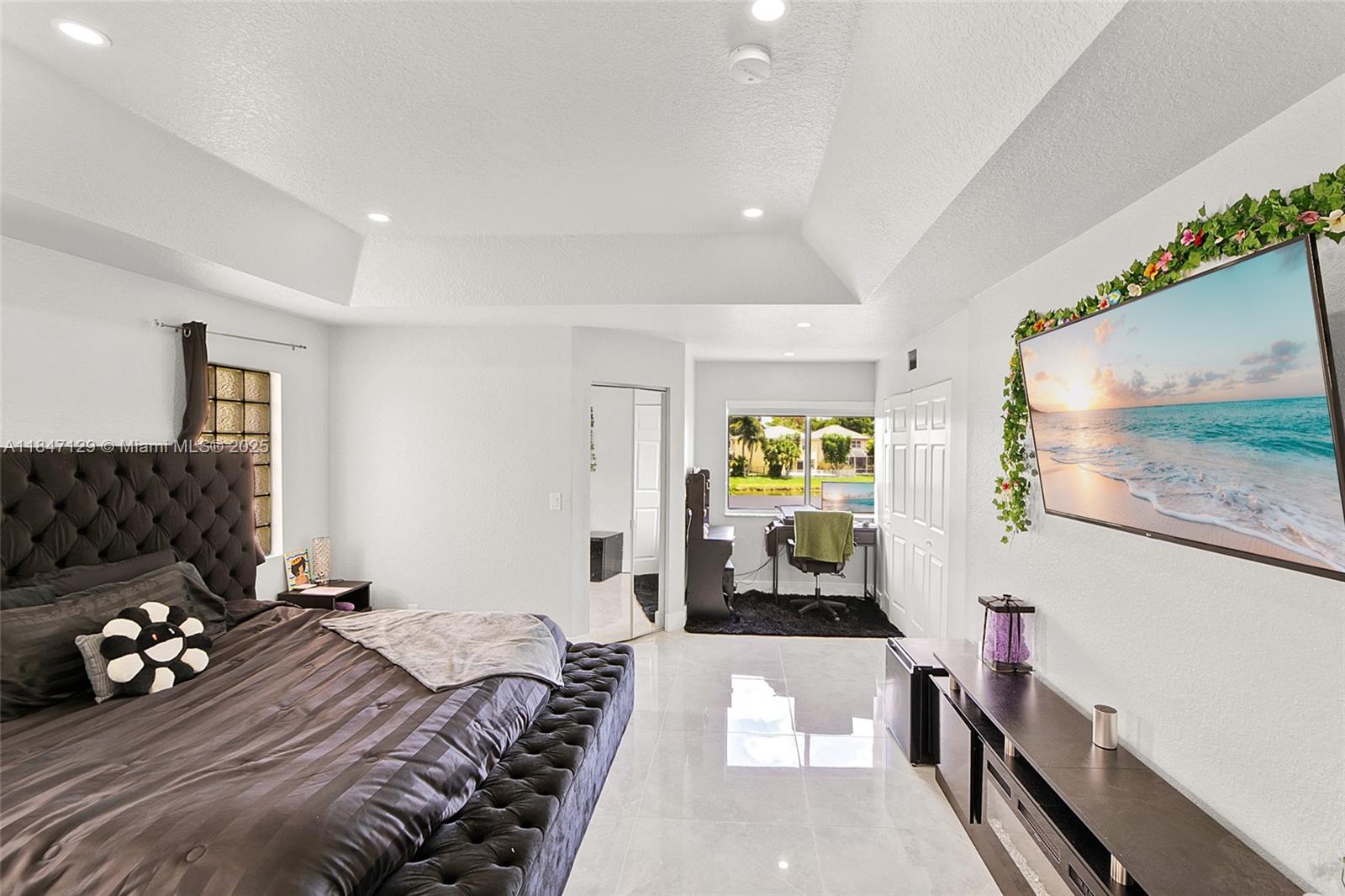 6073 Spring Isles Boulevard Lake Worth, FL 33463 - Photo 27 of 51 a bedroom with a bed and a couch