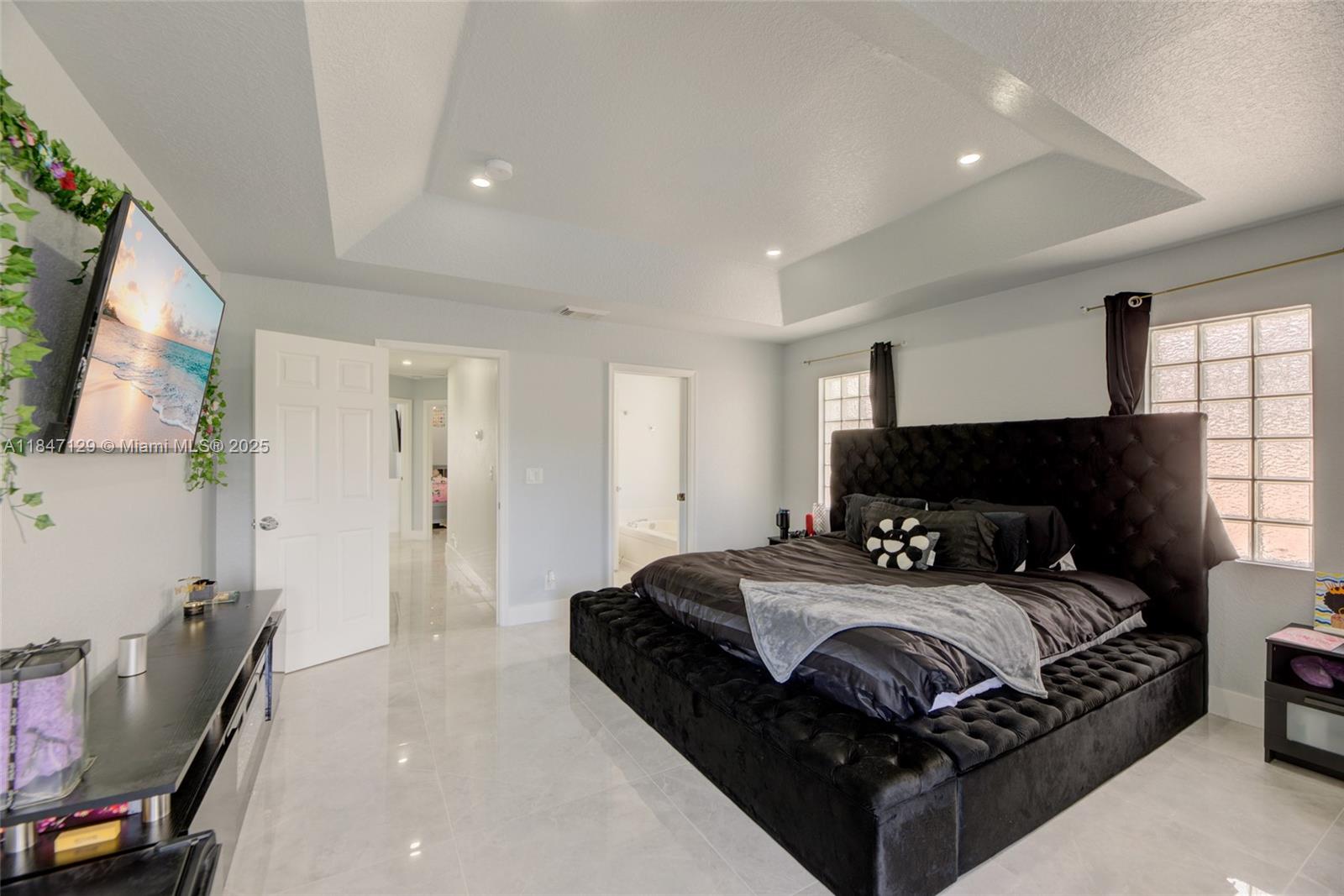 6073 Spring Isles Boulevard Lake Worth, FL 33463 - Photo 29 of 51 a bedroom with a bed a couch and dresser