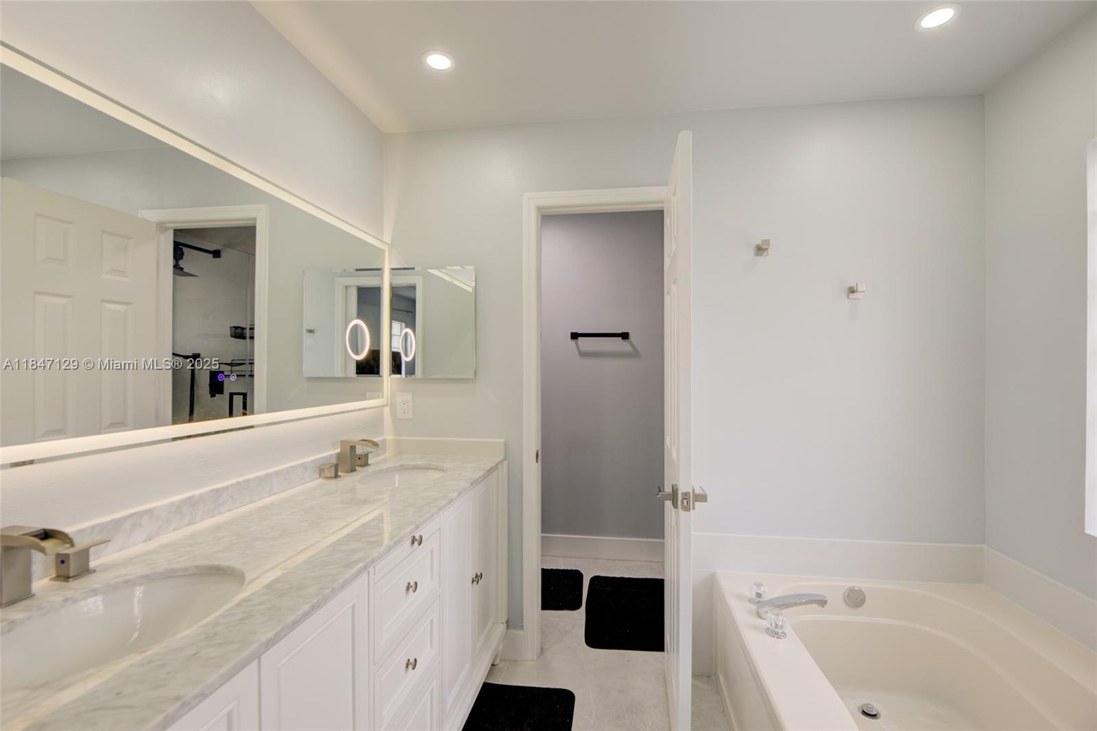 6073 Spring Isles Boulevard Lake Worth, FL 33463 - Photo 31 of 51 a bathroom with a tub sink and mirror