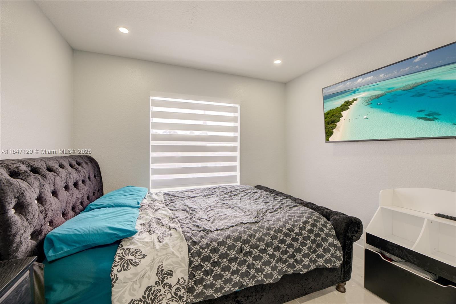 6073 Spring Isles Boulevard Lake Worth, FL 33463 - Photo 37 of 51 a bedroom with a bed and a window