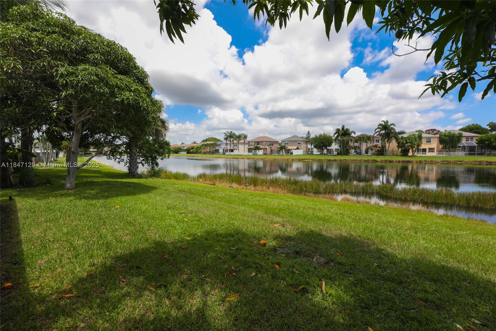 6073 Spring Isles Boulevard Lake Worth, FL 33463 - Photo 44 of 51 a view of a lake with a big yard