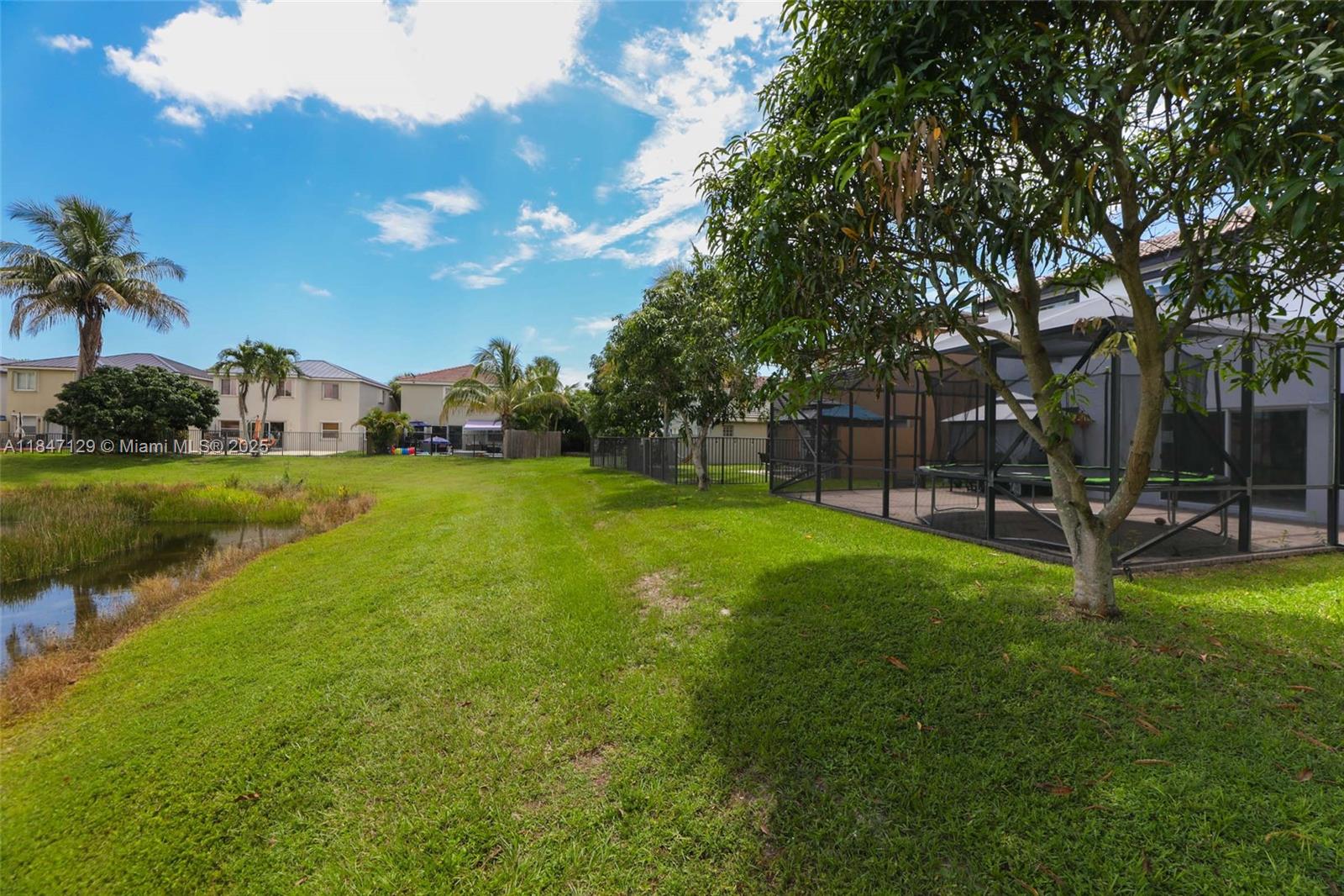 6073 Spring Isles Boulevard Lake Worth, FL 33463 - Photo 46 of 51 a view of a backyard with a garden and entertaining space
