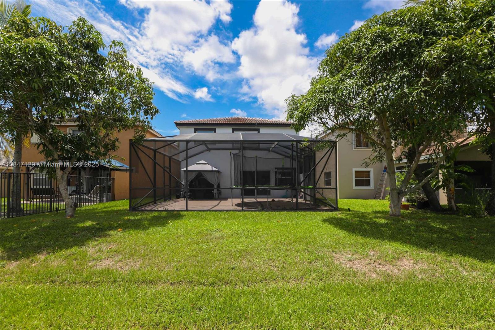 6073 Spring Isles Boulevard Lake Worth, FL 33463 - Photo 47 of 51 a view of a house with a yard and sitting area