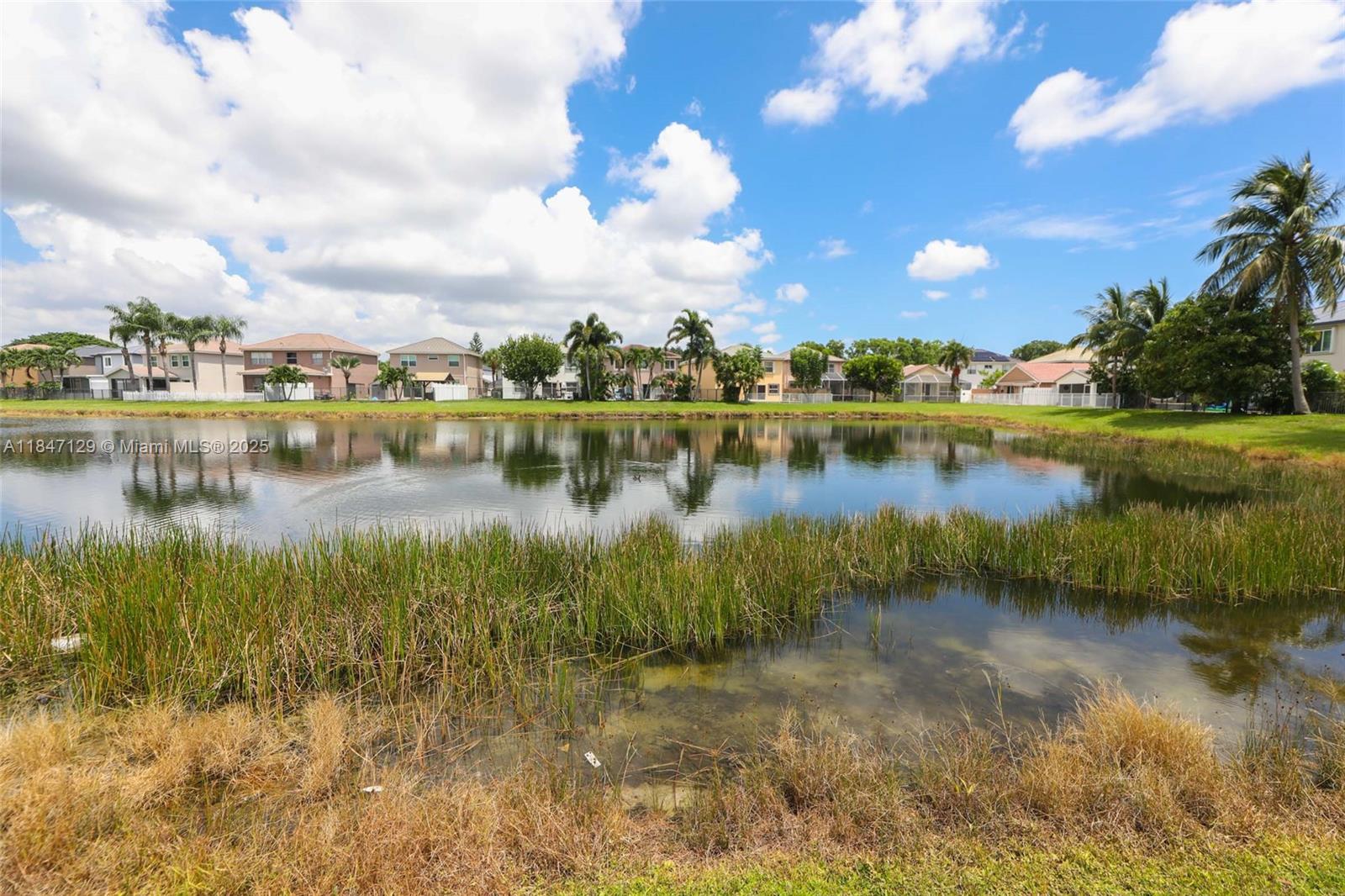 6073 Spring Isles Boulevard Lake Worth, FL 33463 - Photo 48 of 51 a view of a lake in front of house