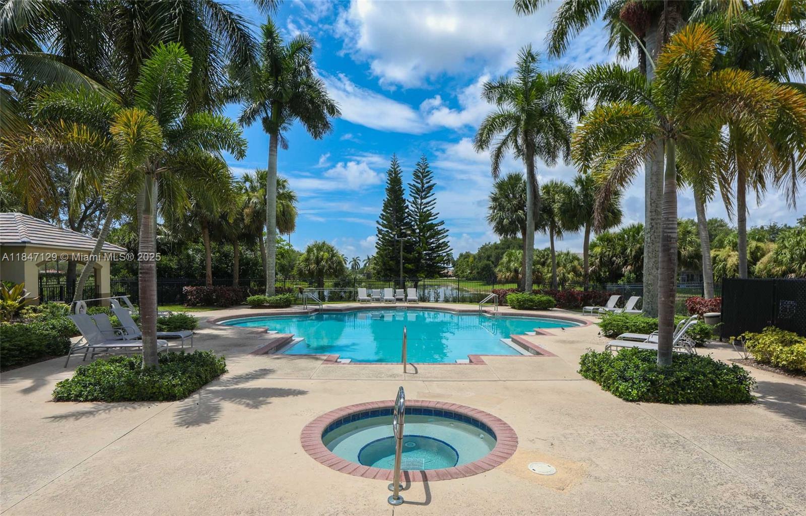 6073 Spring Isles Boulevard Lake Worth, FL 33463 - Photo 49 of 51 a swimming pool with an outdoor seating and yard