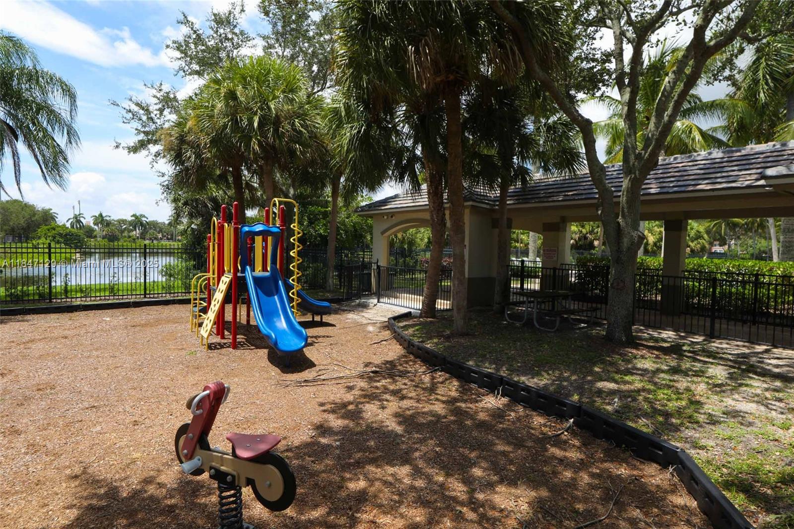 6073 Spring Isles Boulevard Lake Worth, FL 33463 - Photo 50 of 51 a view of a park with slide and a tree