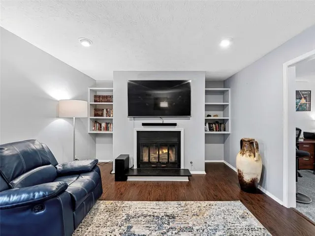 a living room with furniture and a fireplace