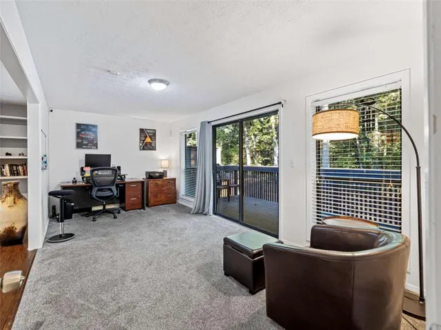 a living room with furniture and a floor to ceiling window