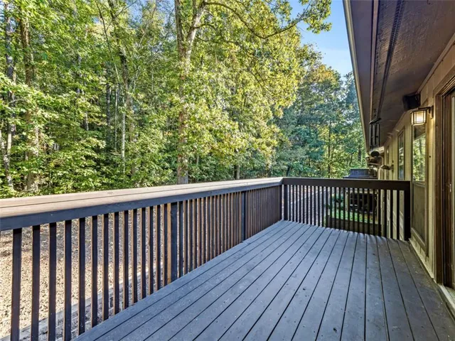 a balcony with wooden floor and fence