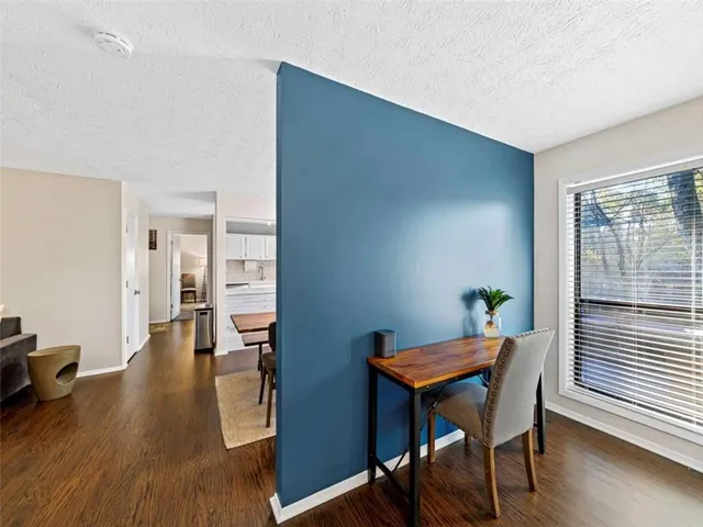 a view of a livingroom with furniture wooden floor and a window