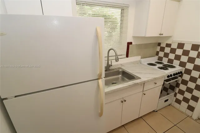a kitchen with a sink and a refrigerator