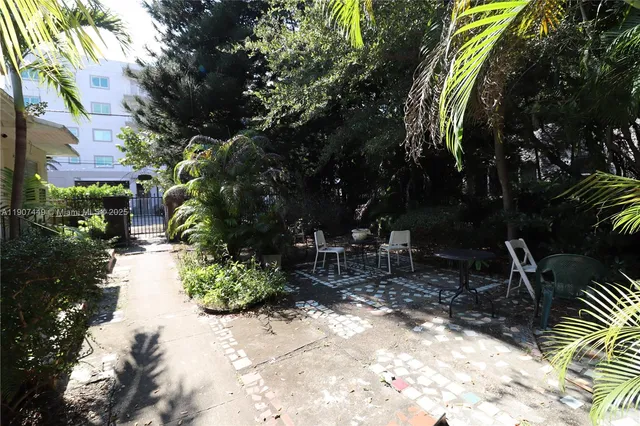 a view of backyard with swimming pool and sitting area