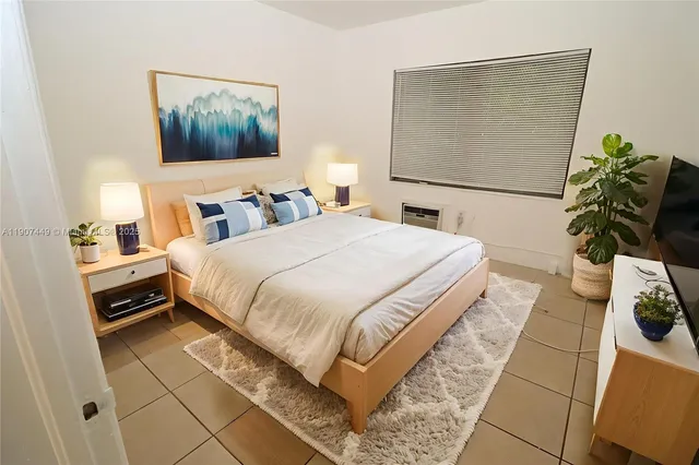 a bedroom with a bed and a potted plant